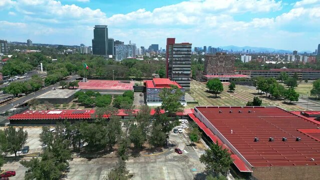 Aerial view of amazing and picturesque view of contemporary University City located in Mexico on sunny day under blue sky with clouds