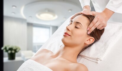 Fototapeta na wymiar Beautiful young Woman Getting Lifting Face Massage In Spa Salon