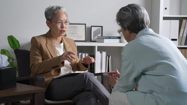 Therapist, psychologist talking and counselling to Asian patient at office during psychology treatment.