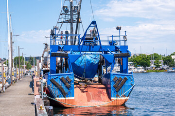 Industrial fishing boat: stern trawler (blue, shot from the back showing transom and trawl ramp)...
