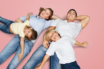 Young parents with child posing together on background