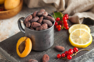 Cocoa beans in a metal mug. Cocoa beans with the aroma of apricot, red currant.
