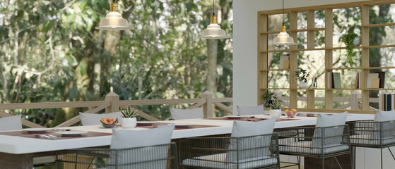 A modern and cozy dining room with a large dining table and beautiful nature view
