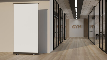 An empty mockup poster stand on the floor in a modern contemporary gym hallway or corridor.