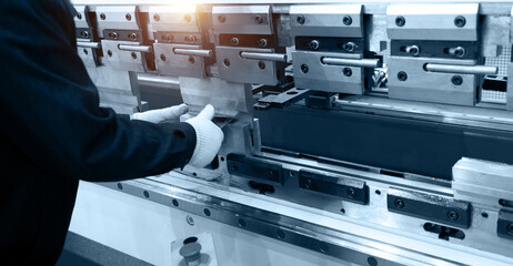 The technician operator use metal cutting and bending machine