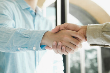 Businessmans handshake after good deal.