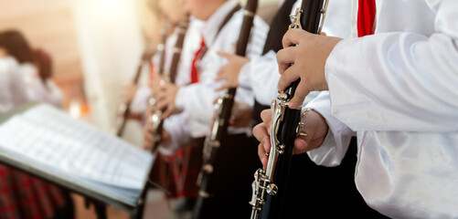 Group of pupils playing the clarinet in a row