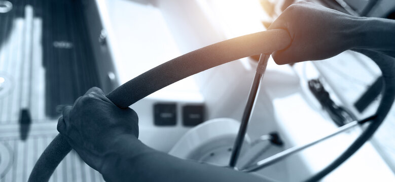 Captain at the helm of a sailboat