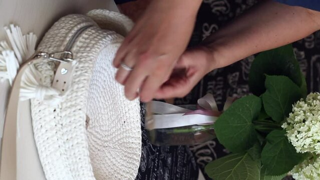 A woman demonstrates a homemade hand-knitted bag. Vertical Video. Close-up.