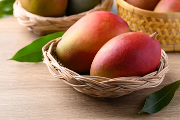 Mango fruit (Palmer mango) in basket on wooden background, Tropical fruit