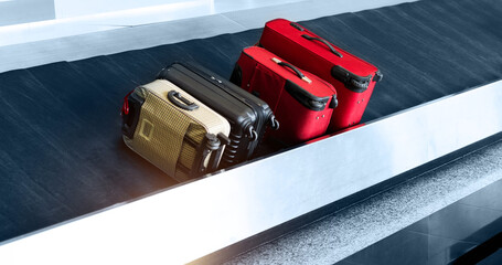 Suitcases on conveyor belt of airport