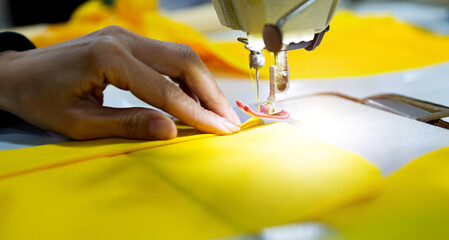 Hand sewing a material on machine