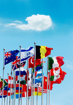 Set of flags fluttering in the wind against blue sky background