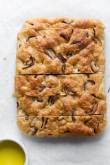 Top view of homemade onion focaccia on a white background, Flatlay of focaccia with red onion topping, fresh homemade focaccia bread