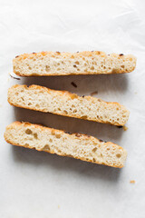 Top view of homemade focaccia on a white background, Flatlay of fresh homemade focaccia bread