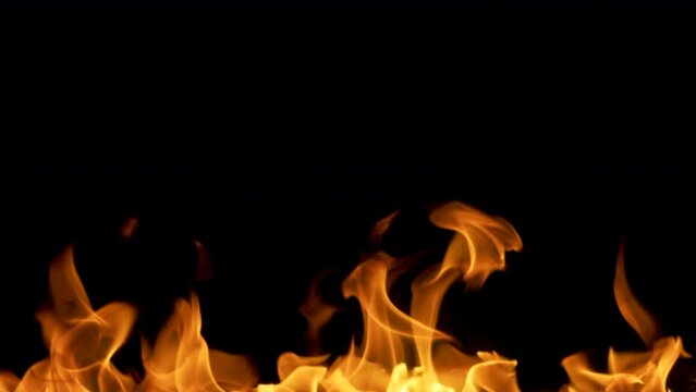 4k Slow Motion Shot Fire Flames Isolated on Black Background moving burning pattern background hot as inferno flame concept, abstract fire texture editing software support blending Screen modes.