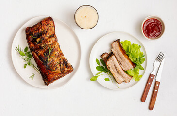 Grilled pork ribs with green salad. Food background with copy space.