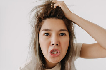 Asian man make funny teasing face for humor isolated on white.