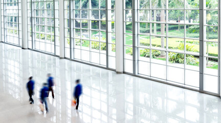 Plakat Group of business people walking in glass building