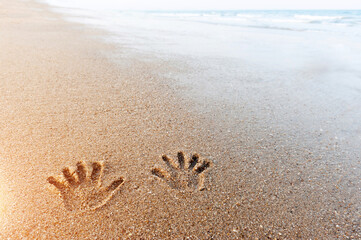 Pair of hand prints on the sand
