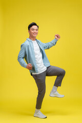 Fototapeta na wymiar Portrait of young male cheerful confident and excited jump in air and smile at studio.