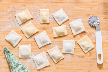 Preparing ravioli with ricotta cheese and spinach. Fresh homemade pasta. Traditional Italian food.