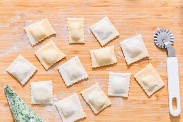 Preparing ravioli with ricotta cheese and spinach. Fresh homemade pasta. Traditional Italian food.