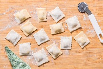 Preparing ravioli with ricotta cheese and spinach. Fresh homemade pasta. Traditional Italian food.