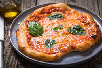 Homemade rustic pizza, prepared on traditional way. Classic Italian Margherita with Mozzarella...