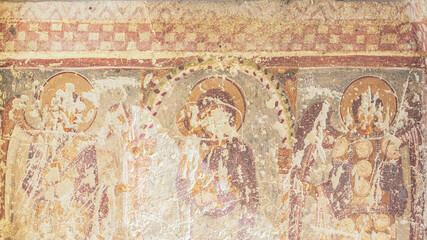 Fresco of Virgin Our Lady and archangels. Partially destroyed painting at the outer wall of Dark Church. Goreme Open air museum, Cappadocia, Turkey. Restoration and heritage preservation concept.