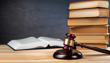 Judge gavel with books on wooden table