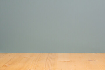 Empty wooden table against a gray-green wall. Mockup, blank for presentation, product branding,...