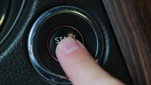 Short video finger pressing a button to start a car engine. Finger confidently engages the button, initiating the car's ignition process. Automotive technology, convenience, easy ignition, excitement.
