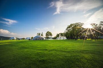 Camping tent on the grass in a sunny day - obrazy, fototapety, plakaty