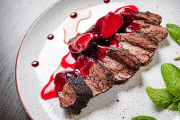 meat with cranberyy sauce and herbs