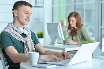 young man and woman working in office