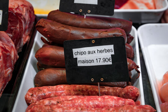 Chipolata fresh sausage with onions and herbs and boudin noir blood sausage for sale at a typical French butcher shop in the old town Antibes, France