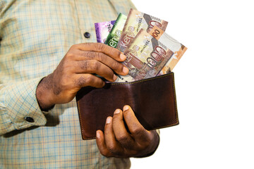 Black person Holding brown wallet
With Kenyan shilling notes, hand removing money out of wallet...