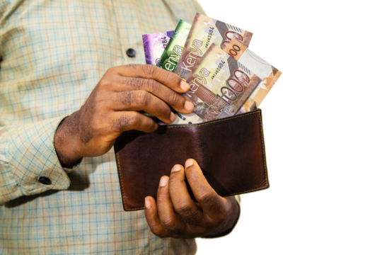 Black person Holding brown wallet
With Kenyan shilling notes, hand removing money out of wallet over white background removing money from wallet