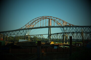 Mountaineer train crossing Pattullo arch bridge Pattullo Bridge over The Fraser River Surrey, British Columbia, Canada. Long exposure of the bridge over the water. Sky Train Bridge.