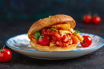 Italian focaccia bun with chicken and vegetables.