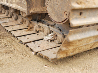 Metal excavator track background. Construction site sandy ground. House building background. Heavy machinery equipment