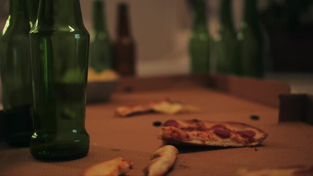 Close up of empty bottles, snack on table after party in living room.