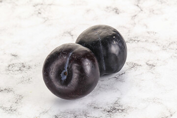 Two ripe sweet black plums