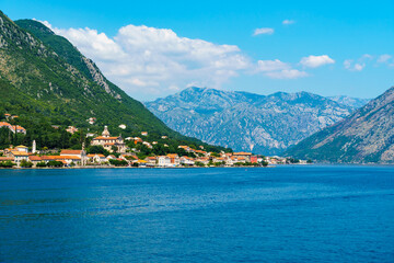 seascapes, a view of the Bay of Kotor during a cruise on a ship in Montenegro, a bright sunny day, mountains and small towns on the coast, the concept of a summer trip
