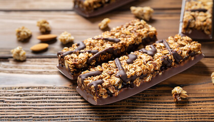 Obraz na płótnie Canvas Tasty chocolate granola bars on wooden table