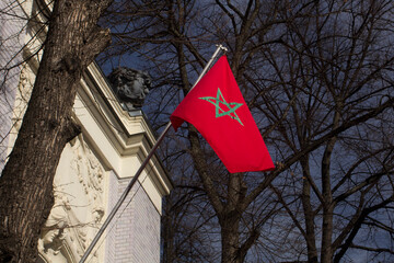 Moroccan national flag. Moroccan flag at the Moroccan embassy in Moscow. العلم المغربي. The Moroccan flag hangs from a flagpole. Close up. Bottom up view.