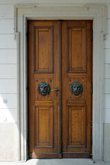 Details of building structures. Entrance external double-leaf door with molded lion handles.