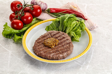 Frilled beef burger cutlet with iceberg