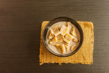 The cup of bananas in coconut milk